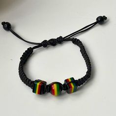 Feel the island vibes with this adjustable braided cord and reggae rasta beads bracelet for him or/and for her! This stylish bracelet is made with a high-quality cord that was hand braided and can be adjusted to fit any wrist size. The bracelet is adorned with colourful rasta beads, inspired by the Rastafarian movement and reggae music. Here are some of the features of this bracelet: *Adjustable braided cord for a perfect fit *Colourful rasta beads in red, green, and yellow *Lightweight and comfortable to wear. *Makes a great gift for yourself or a friend. This bracelet is perfect for anyone who loves reggae music, or Rastafarian culture, or simply wants to add a pop of colour to their outfit. Product details: *Material: waxed cord, rasta beads *Colour: Red, green, yellow *Size: Adjustable Rastafarian Culture, Bracelet For Him, Unisex Gift, Stylish Bracelet, Reggae Music, Braided Bracelet, Island Vibes, Unisex Gifts, Green And Yellow