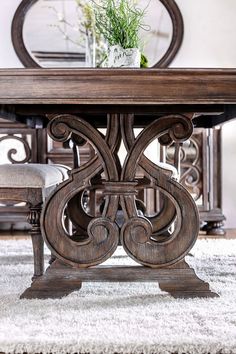 a wooden table sitting on top of a white rug