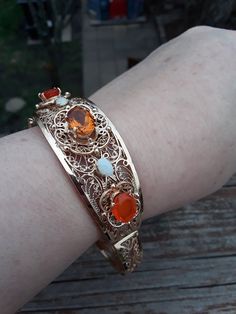 Stunning 14k Yellow Gold, Citrine, Mexican Fire Opal, Opal Bangle Bracelet.. Weight is 35.6 Grams. Safety chain. Perfect Vintage Condition... Elegant Orange Bangle Jewelry, Elegant Handmade Orange Bracelets, Elegant Orange Bangle Bracelet, Heirloom Gemstone Bangle Bracelets, Heirloom Gemstone Bangle Bracelet, Orange Bracelet For Formal Occasions, Formal Orange Bracelet Jewelry, Formal Orange Bracelet, Handmade Oval Bangle For Formal Occasions