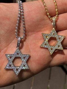 Gorgeous Star of David pendant!
SUPER ICY!
Solid 925 sterling silver
We have 2 styles! Rhodium finished & 14k yellow gold finished!
Measures roughly 1" by 1" (1.25" w. bale)...weighs roughly 5 grams
70 micropaved handset man made diamonds (CZ) for a total of 0.7ct!
SO ICY IT WILL BLIND YOU!
 
100% 925 silver...not plated or filled...will NEVER TARNISH OR CHANGE COLOR
You can buy pendant only or with choice of 18-30" 2.5mm diamond cut ball moon chains
Chains are also solid ster Gold Star Of David Jewelry For Anniversary, Silver Star Of David Jewelry Tarnish Resistant, Silver 14k Gold Necklace With Star Charm, White Star Of David Jewelry For Anniversary, Silver Star Of David Jewelry In 14k Gold, Star Of David Charm Jewelry For Anniversary, White Gold Star-shaped 14k Gold Jewelry, Silver Cubic Zirconia Star Of David Jewelry, White Gold Cubic Zirconia Star Of David Jewelry