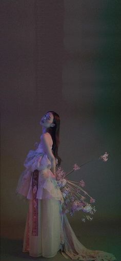 a woman in a white dress holding flowers