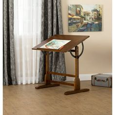 a wooden easel with a painting on it in front of a curtained window