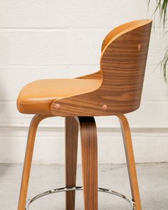 an image of a wooden stool with leather seat cover on the back and footrests