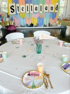 a table set up for a party with confetti and napkins on it