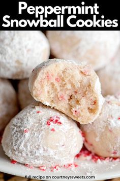 a white plate topped with snowball cookies and candy canes