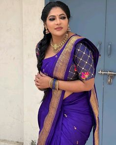 a woman in a blue sari posing for the camera