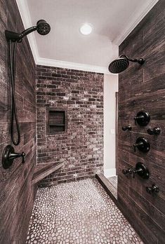 a walk in shower sitting next to a brick wall