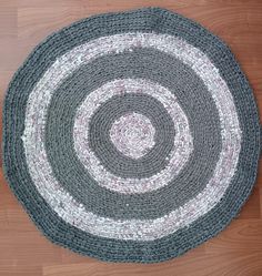 a round rug on top of a wooden floor