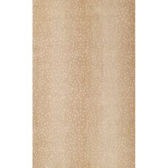 a beige rug with white dots on it