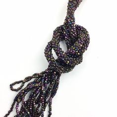 "Vintage 20s Iridescent Beaded Sautoir Lariat Necklace with Fringed Tassels, Eggplant Purple, Copper Brown, 54\", Art Deco Flapper Accessories COLOR: Wonderful dark iridescent beads with hints of pinkish purple and copper. MATERIAL: Steel cut seed beads. MEASUREMENTS: 54 in.(137 cm) WEIGHT: 40 g. CONDITION: Excellent. For more items like this: https://www.etsy.com/shop/iandrummondvintage PLEASE READ SHIPPING DISCLAIMER: We set our prices based on average shipping costs for domestic and internati Beaded Lariat Tassel Necklace, Beaded Long Lariat Necklace For Party, Beaded Lariat Necklace For Party, Adjustable Lariat Necklace With Tassels For Party, Adjustable Beaded Tassel Necklace For Party, Bohemian Beaded Lariat Necklaces For Party, Bohemian Beaded Lariat Necklace For Parties, Bohemian Lariat Beaded Necklaces For Party, Adjustable Lariat Beaded Necklaces For Parties