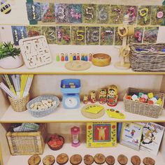 a shelf filled with lots of toys and books on top of wooden shelves next to other items