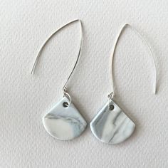 "porcelain and sterling silver long dangle earrings handmade pale blue white gray nerikomi minimalist simple contemporary modern These dangle earrings are handmade by me from porcelain clay and sterling silver. I've used pigments to create porcelain clay of different colors and then combined the clays using various techniques, such as nerikomi, to create a dappled or striated effect. I leave the porcelain unglazed, resulting in a matte surface.  Porcelain is such a special material: strong, yet Minimalist Gray Jewelry For Everyday, Gray Minimalist Jewelry For Everyday, Gray Minimalist Jewelry For Everyday Wear, Minimalist Gray Sterling Silver Jewelry, White Minimalist Long Drop Earrings, Everyday White Linear Earrings With Ear Wire, White Minimalist Dangle Linear Earrings, Minimalist White Dangle Linear Earrings, Minimalist White Linear Long Drop Earrings