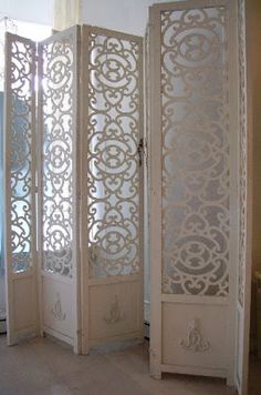 the room divider is made out of wood and has an intricate design on it