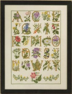 a cross stitch pattern with flowers and letters