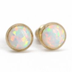 These opal stud earrings are beautiful. They feature a single 6mm simulated opal cabochons. Hand bezel set in my studio. 6mm Simulated Opal Round Cabochons Solid 925 Sterling Silver or 14/20 Gold Filled Deluxe Luxlock Backs-Safe, Secure, Comfortable Artisan Made in Texas Arrives thoughtfully packaged in a signature jewelry box Check out all of my opal earrings: https://www.etsy.com/shop/KMBankston/search?search_query=opal+earring&order=date_desc&view_type=gallery&ref=shop_search ~ Ab Classic Opal Cabochon Jewelry, Hypoallergenic Round Opal Jewelry, Minimalist Ethiopian Opal Round Jewelry, Yellow Gold Opal Jewelry In Round Shape, Yellow Gold Round Opal Jewelry, Classic Opal Jewelry As A Gift, Classic Opal Jewelry For Gifts, Dainty Round Ethiopian Opal Jewelry, Round Ethiopian Opal Jewelry For Gift