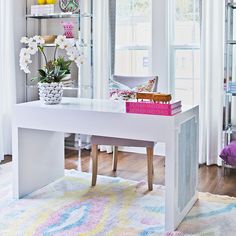 a white table with flowers and books on it