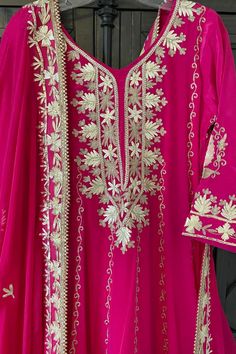 This beautifully designed Hot Pink Hand Embroidered Silk Anarkali Dress is crafted with intricate Tilla and Gotta work, creating a stunning choice for any special event. This dress includes a matching silk churidar bottom and a 2.5 meter pure chinon silk embroidered dupatta chunni, perfect for weddings and parties. Silk Chinon Silk Dupatta 2.5 meter Lined Hand Embroidered String tie back with zipper Churidar bottom Full elastic waist band Work: Handcrafted gotta work, tilla work Condition: New O Silk Anarkali Dress, Hand Work Dupatta, Phulkari Pants, Lucknowi Kurta, Silk Churidar, Silk Anarkali, Bridal Dupatta, Phulkari Dupatta, Chikankari Suits