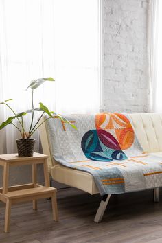 a living room with a couch and potted plant