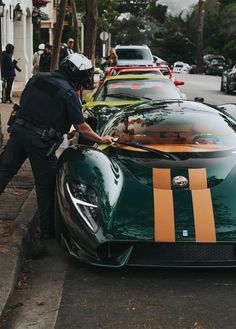 a police officer standing next to a green sports car