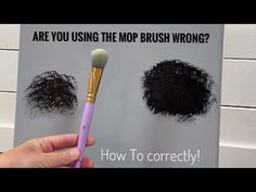 a person holding a brush in front of a sign with black powder on it and the words are you using the mop brush wrong?