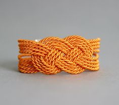 This bright oramge knot bracelet created from decorative rope and clasp in silver tone metal. Perfect jewelry for everyday wear! NOTE: the last photo gives an idea how it will look on a person. Length: 17-18 + 5 cm of chain. A wonderful jewelry and a great gift! I made it in a smoke-free and pet-free invironment. Other bracelets of my shop you can see here: https://www.etsy.com/shop/NaTavelli?section_id=13470528 Thanks for your visit! Orange Bangles, Jewelry Rope, Bracelet Tie, Tie Jewelry, Sailor Knot Bracelet, Sailor Knot, Bracelet Rope, Twist Jewelry, Knot Jewelry