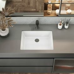 a white sink sitting on top of a gray counter