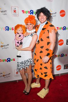 two people in costumes posing for a photo on the red carpet at toys r us