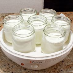 several jars filled with liquid sitting on top of a counter