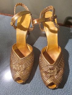 Amazing gold shoes that look like they came right out of a fairytale from the 30s. These are in great antique wearable condition with just some scuffing on the heels and one shoe liner in loose. These are made in Los Angeles by JW Robinson Company. I can't make outnthe size by all.the numbers on the strap. Says 5274 75 22 maybe 7.5? I'm a 8 and can barely squeeze.  They are narrow and my foot is wide. I would suggest a small 7.5 with a narrow foot or a size 7 foot that is narrow.  Also I am prov Woven Sandals, Gold Shoes, Women's Costumes, Bridal Wedding, Gatsby, Vintage Collection, Wedding Bridal, Ankle Strap, Gold Metal