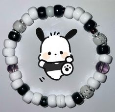 a white and black beaded bracelet with an image of a baby animal on it