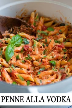 a pot filled with pasta and sauce on top of a table