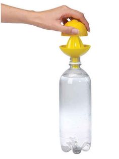 a hand is holding a yellow plastic bottle