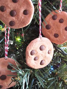 three cookies hanging from a christmas tree