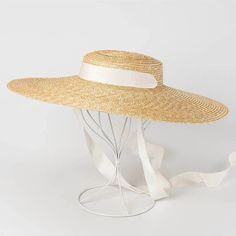 Complete your summer look with our Wide Brim Straw Boater Hat, a timeless accessory for sunny days. Crafted from straw, this boater hat features a wide brim that offers stylish sun protection. Perfect for beach outings or picnics, its classic design adds a touch of vintage charm to any outfit. Casual Straw Hat, Straw Boater Hat, Straw Boater, Black And White Ribbon, Floppy Sun Hats, Wide Brim Sun Hat, نظارات شمسية, Boater Hat, Kentucky Derby Hat