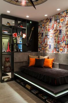 a bed sitting in the middle of a bedroom next to a wall with pictures on it