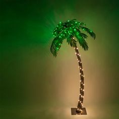 a lighted palm tree with green lights on it