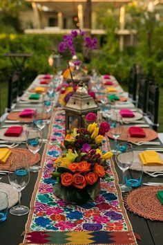 a long table is set with colorful place settings