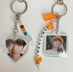 two key chains that have pictures and beads attached to them, one with a photo on it