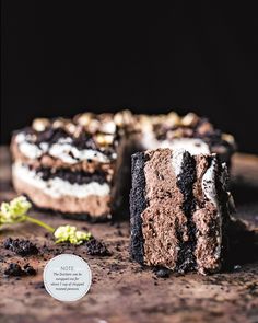 a piece of cake sitting on top of a wooden table next to a small flower