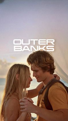 a man and woman standing next to each other in front of the ocean with text that reads, outer banks