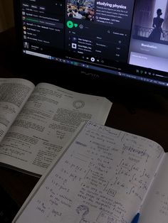 an open book sitting in front of a computer monitor