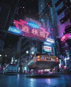 a taxi cab parked in front of a neon sign on a city street at night