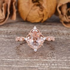 an engagement ring with a pink morganite surrounded by white and rose gold diamond accents