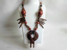 Lovely vintage African necklace. Artisan made wooden necklace. Hand carved Giraffe. Tribal theme. Unusual. Length 62cm ex pendant. Gift idea. Free Shipping Free shipping  from my vintage store, Bags Of Fun in Cyprus. If you are outside of the EU customs charges may apply.   Non-EU customers need to provide a Telephone number and/or email address for the Custom's Declaration (this is not included on the envelope). This is required in case Customs need to contact you regarding your order.  If you' Brown Carved Round Bead Necklaces, Brown Carved Round Beads Necklaces, Unique Carved Brown Necklace, Unique Brown Carved Necklace, Adjustable Carved Brown Necklace, Bohemian Brown Carved Beaded Necklaces, Bohemian Brown Beaded Carved Necklace, Bohemian Brown Carved Beaded Necklace, Brown Carved Pendant Necklace