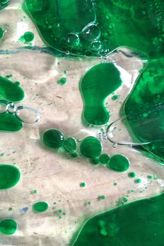 green and white liquid is being mixed together