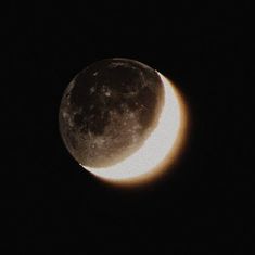 the moon is seen in the dark sky