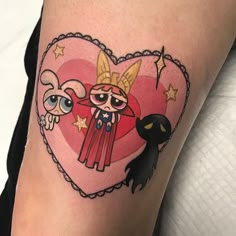 a woman's thigh with an image of two cartoon characters on it and a heart shaped frame