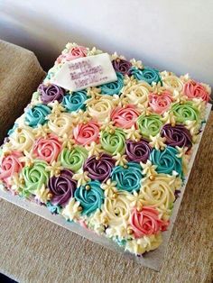 the cake is decorated with multicolored icing