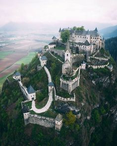 an aerial view of a castle on top of a mountain