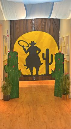 an indoor area with cactus, cacti and a cowboy theme